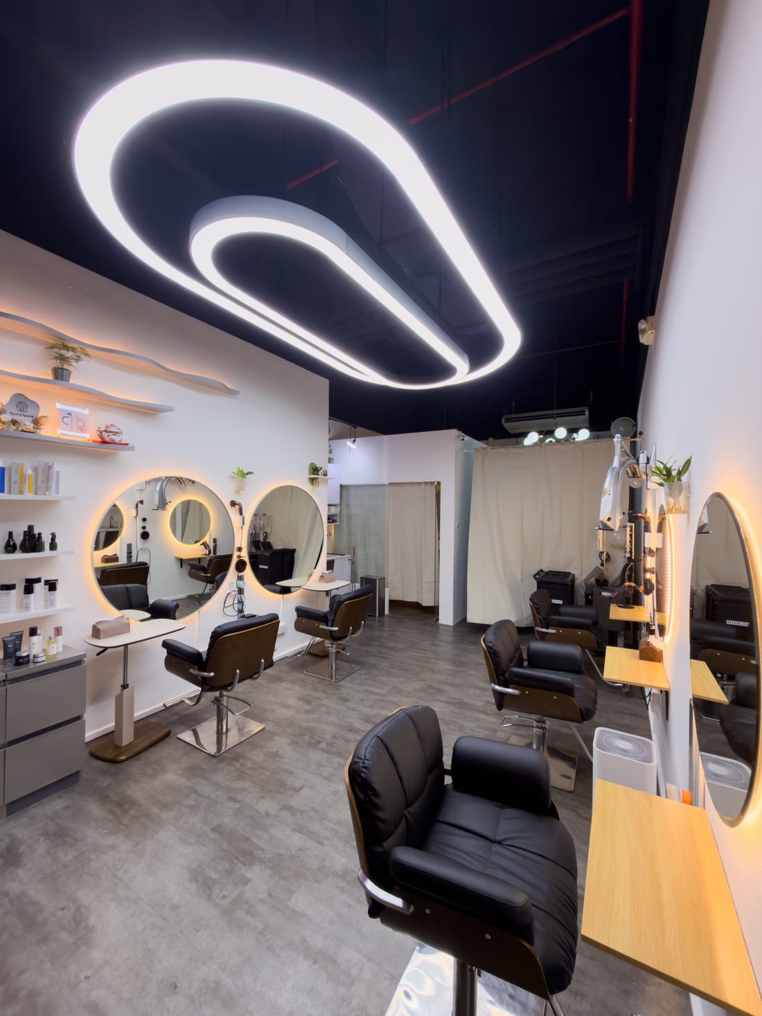 Root & Reverie salon interior — styling stations and mirrors